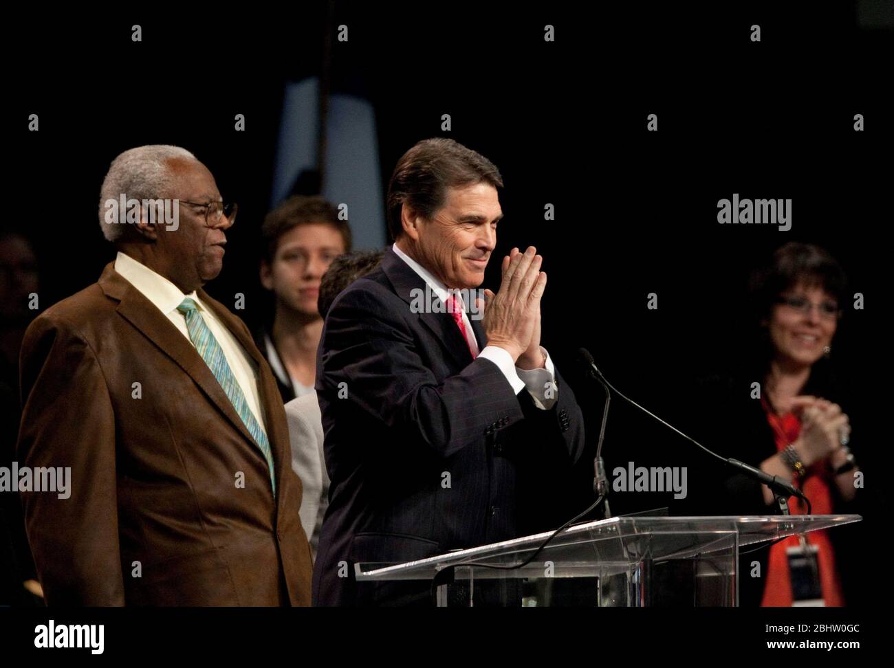 Houston, Texas USA, August 6, 2011: Texas Governor Rick Perry speaks at The Response, a day-long 'call to prayer for a nation in crisis' that attracted over 30,000 worshippers to hear prayers, gospel music and conservative evangelic speakers at Reliant Stadium. Demonstrators outside the arena protested Perry's mixing government and religion by appearing prominently at a Christian prayer event. ©Bob Daemmrich Stock Photo