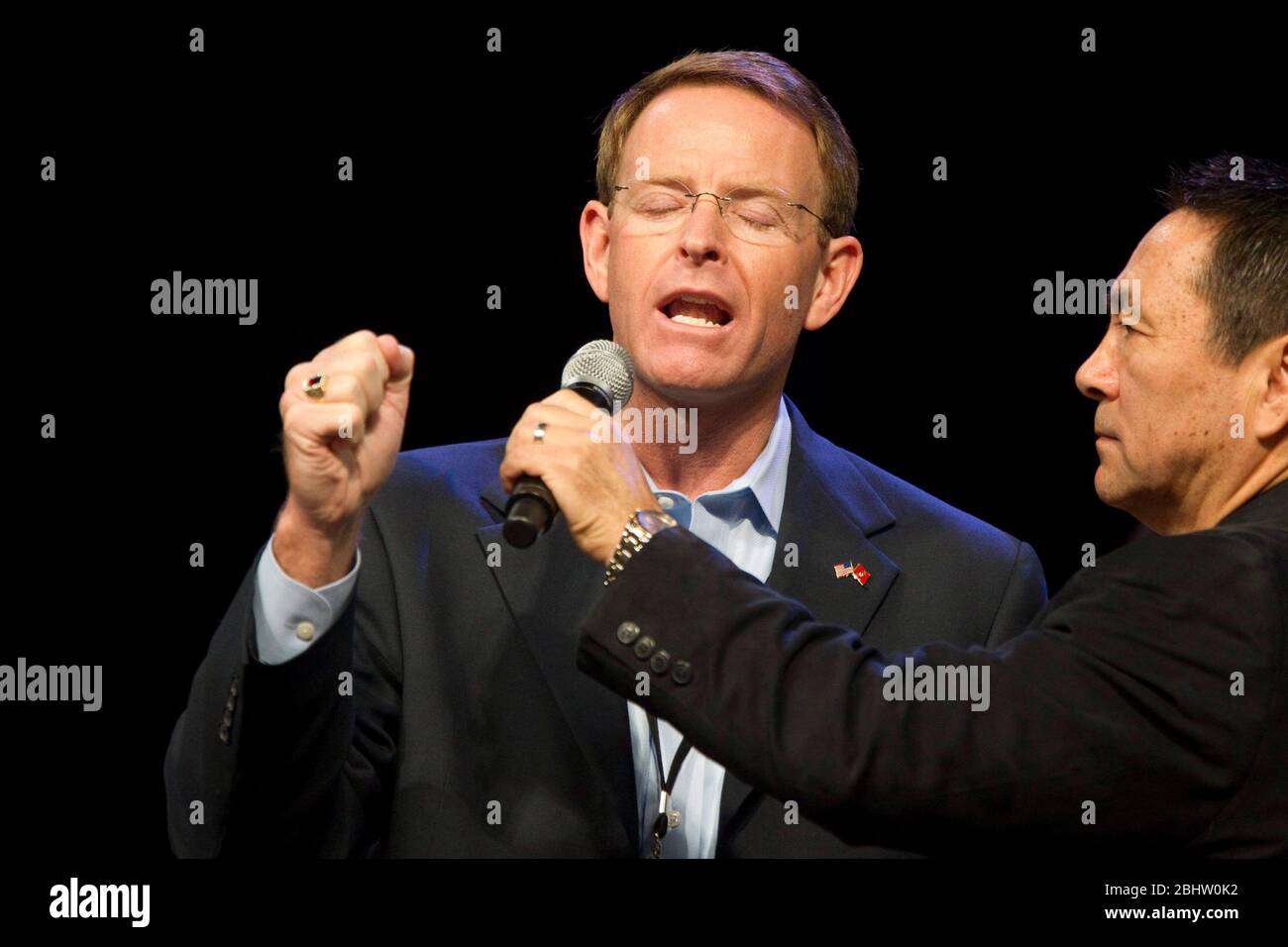 Houston Texas USA, August 6 2011: Tony Perkins, President of the Family Research Council of Washington, D.C., prays onstage during The Response, a day-long 'call to prayer for a nation in crisis' that attracted over 30,000 worshippers to hear prayers, gospel music and conservative evangelic speakers at Reliant Stadium. The event is sponsored by the American Family Association. ©Bob Daemmrich Stock Photo