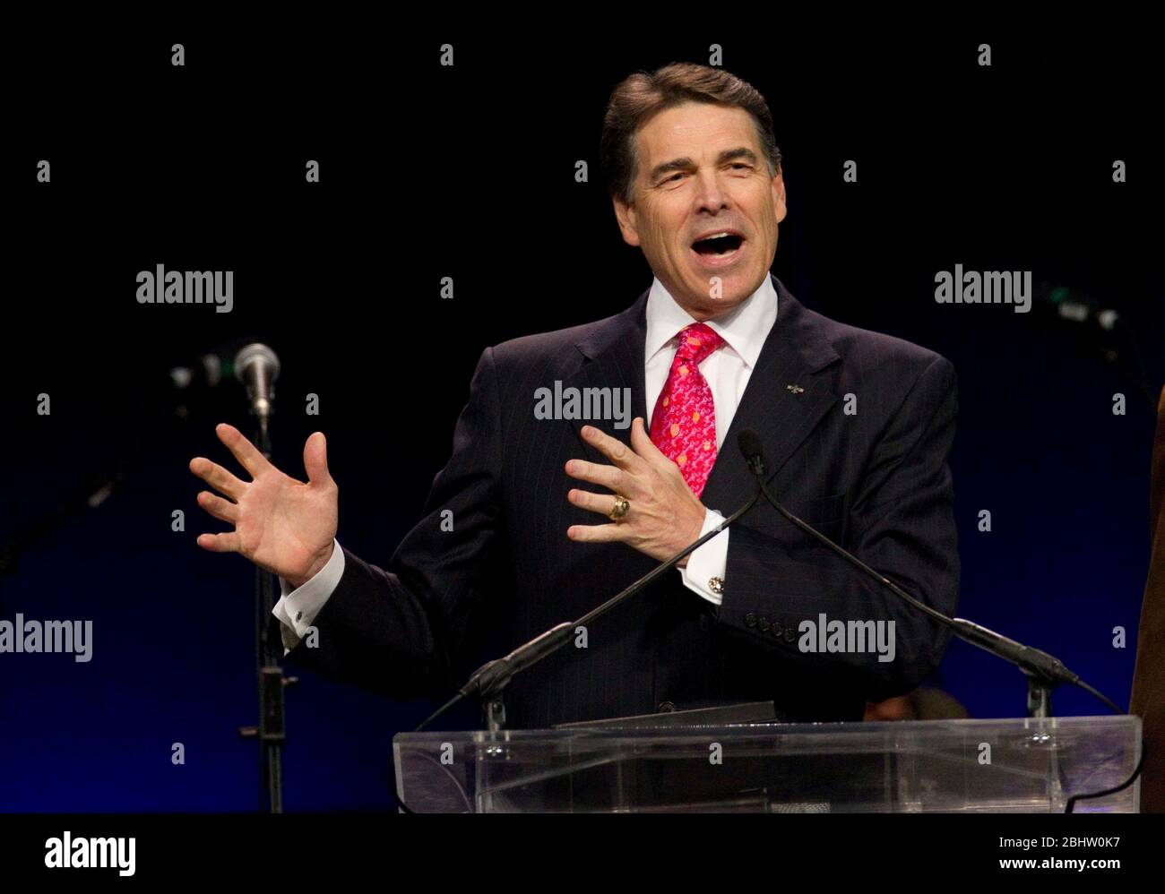 Houston, Texas USA, August 6, 2011: Texas Governor Rick Perry speaks at The Response, a day-long 'call to prayer for a nation in crisis' that attracted over 30,000 worshippers to hear prayers, gospel music and conservative evangelic speakers at Reliant Stadium. Demonstrators outside the arena protested Perry's mixing government and religion by appearing prominently at a Christian prayer event. ©Bob Daemmrich Stock Photo