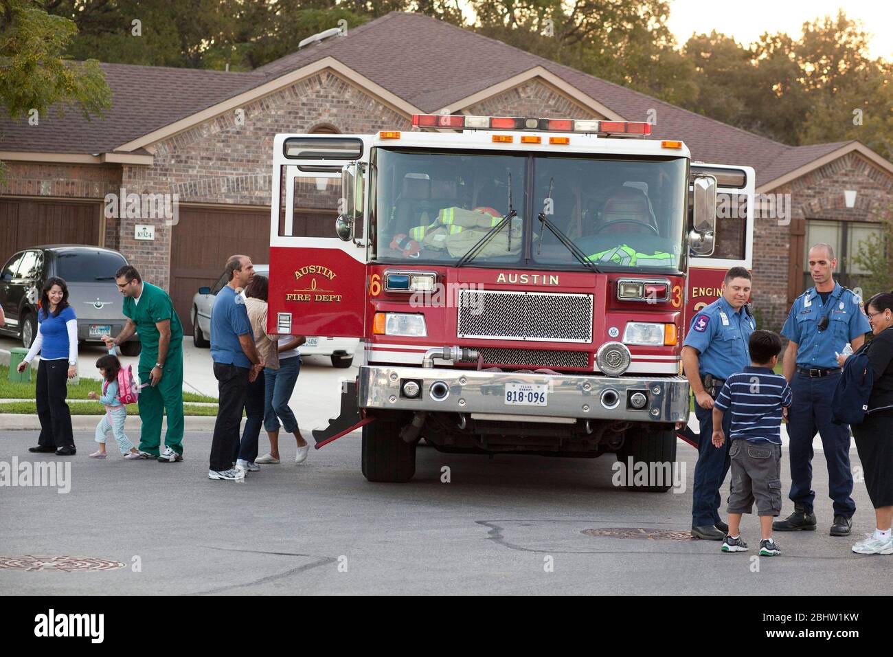 Austin Texas USA, October 5, 2010: Residents of a south Austin neighborhood view a fire truck during National Night Out, a national anti-crime effort aimed at keeping neighborhoods vibrant and safe. Dozens of groups met throughout the city to heighten awareness of crime prevention and foster better police community relations.  ©Bob Daemmrich Stock Photo