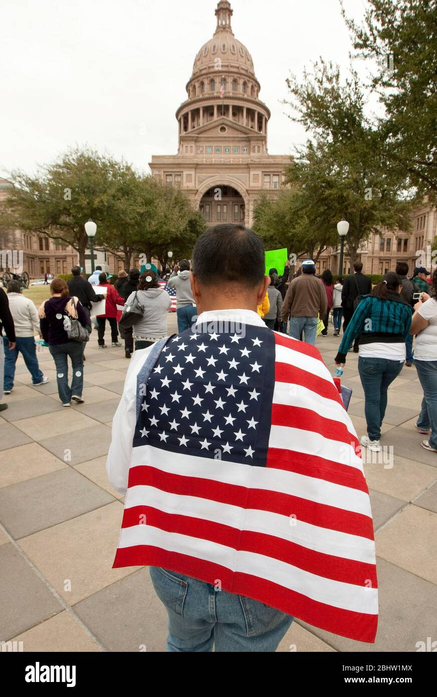 Man draped in US flag marches to Texas Capitol during an immigration rally in Austin. February 22, 2011. ©Marjorie Kamys Cotera / Daemmrich Photos Stock Photo
