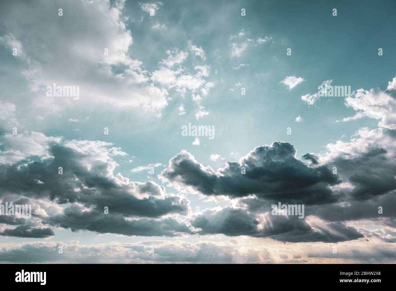 Scenic cloudy color graded sky. Sunlight in high large dramatic cloudscape moody background Stock Photo