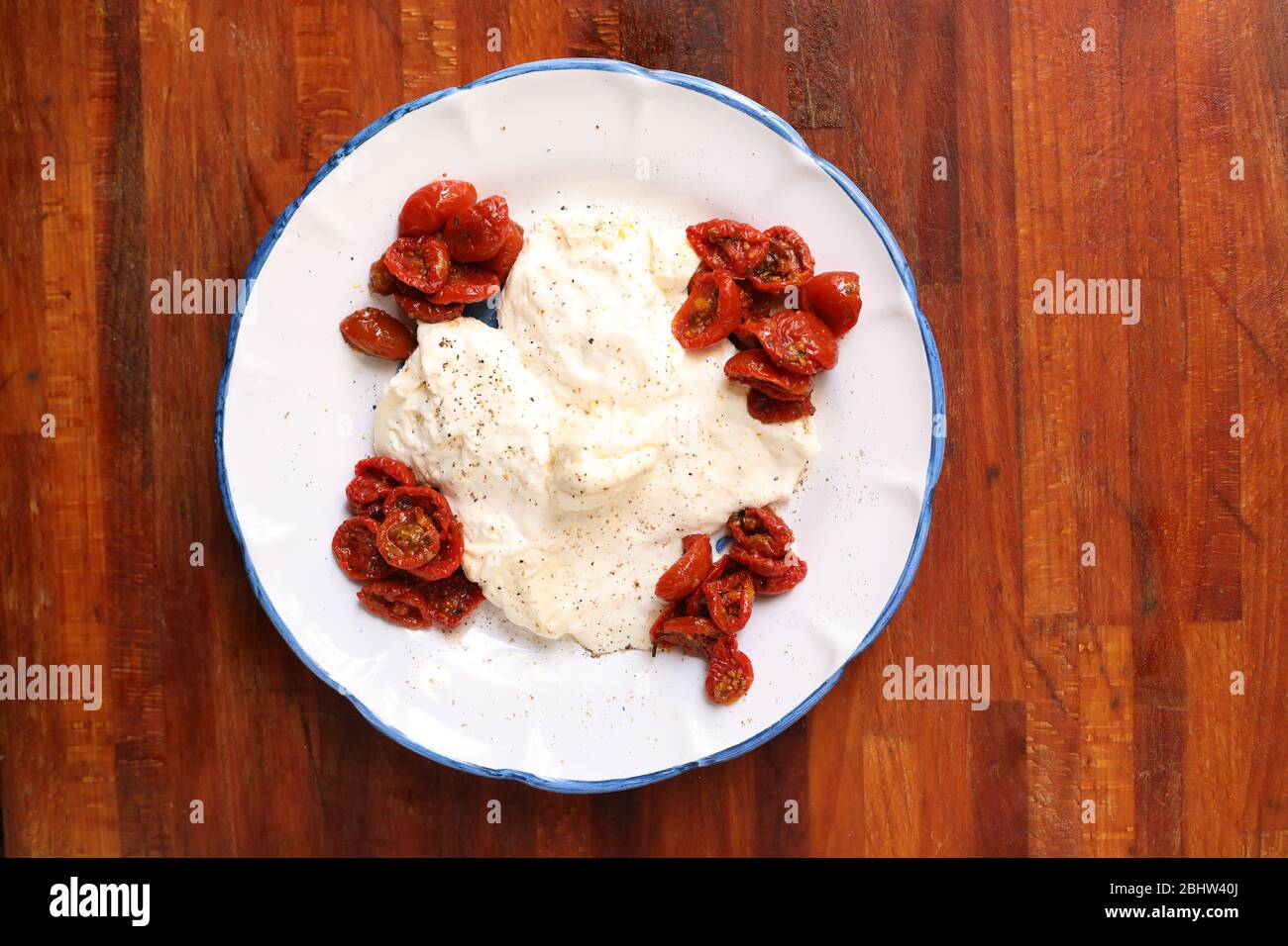 Creamy burrata cheese with sun dried tomatoes Stock Photo Alamy