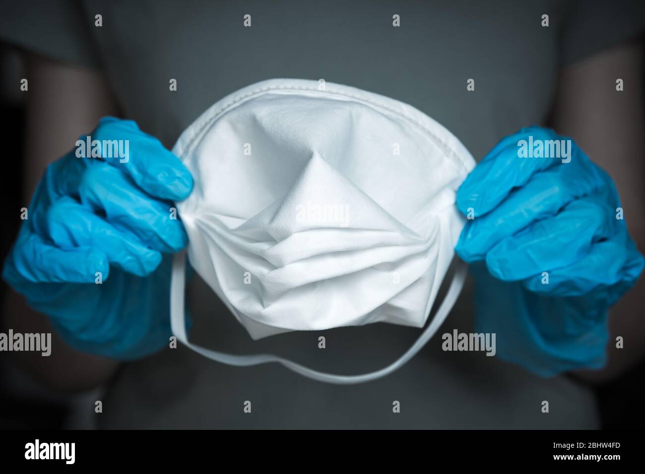 Closeup of gloved hands holding N95 medical face mask Stock Photo Alamy