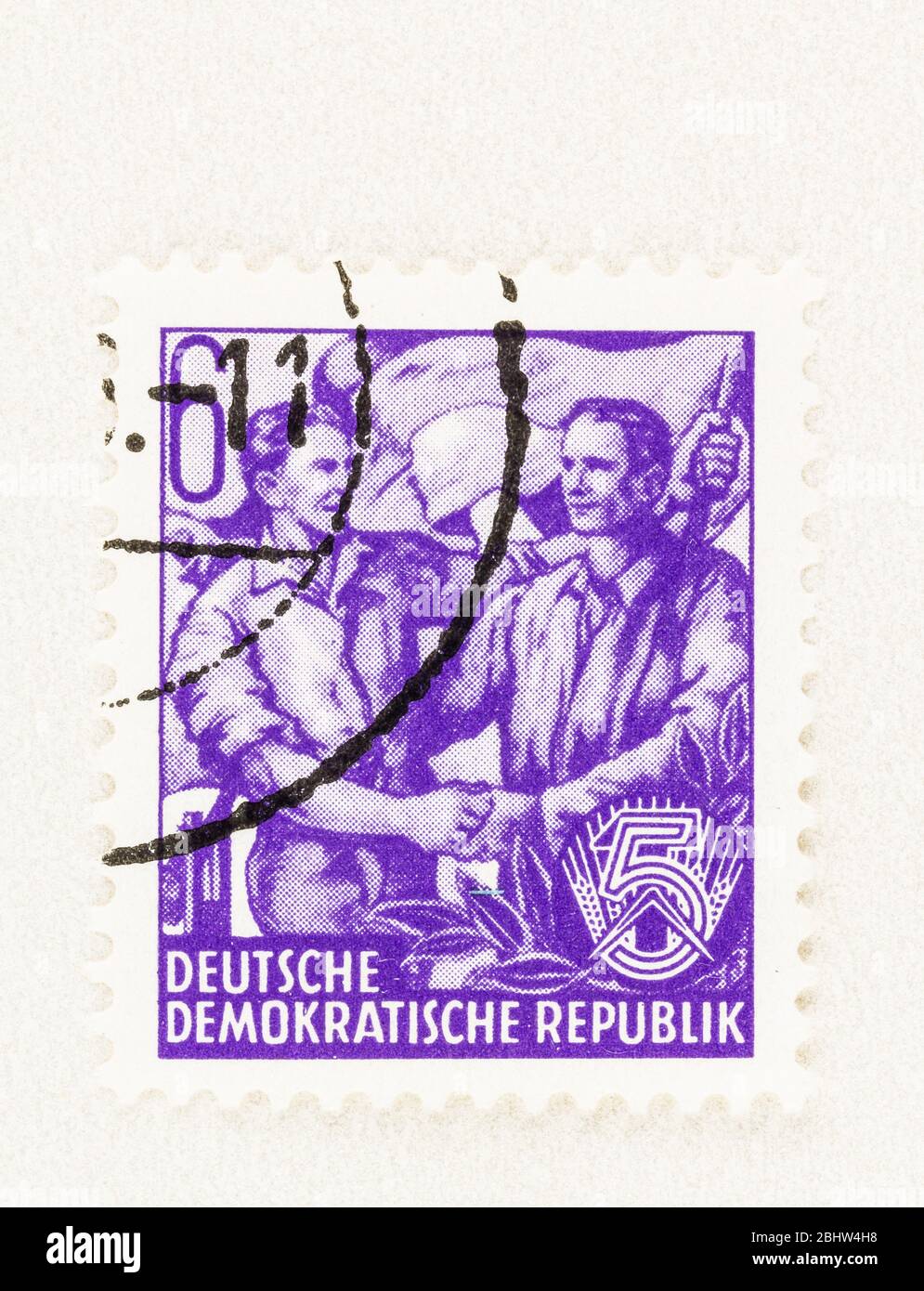 SEATTLE WASHINGTON - April 23, 2020: 1953 East German Stamp featuring German and Soviet workers on a stamp of the Five-Year Plan. Scott # 157 Stock Photo