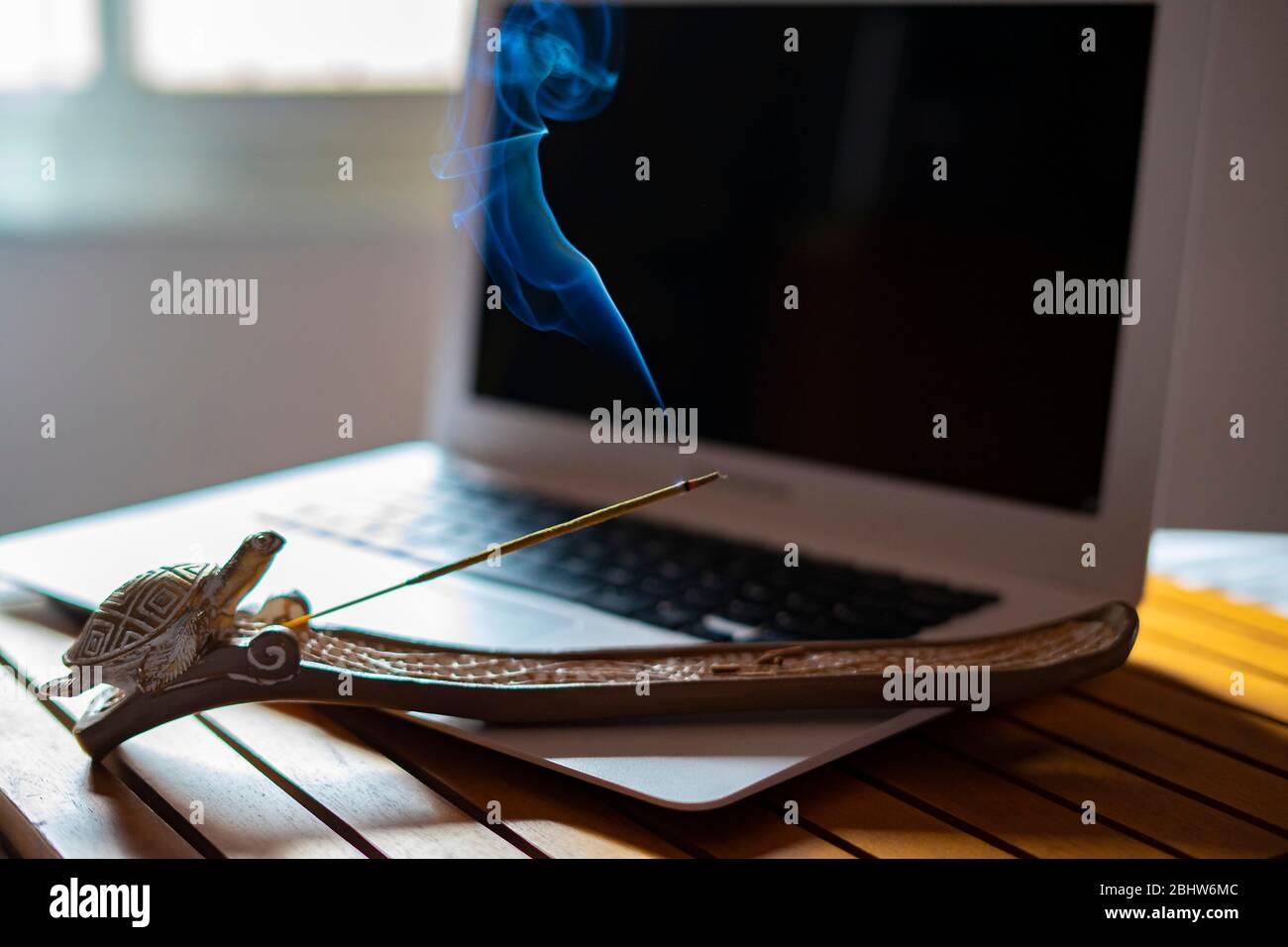 Incense lit next to a computer. Incense at work Concept Stock Photo Alamy