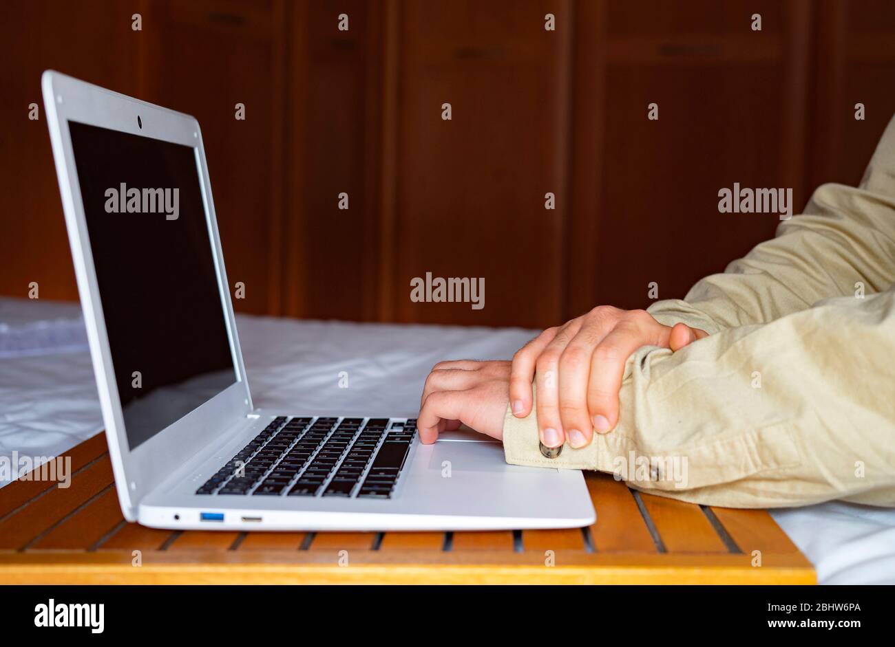worker with wrist pain. Ergonomics at work and in the office. Wrist injury. Stock Photo