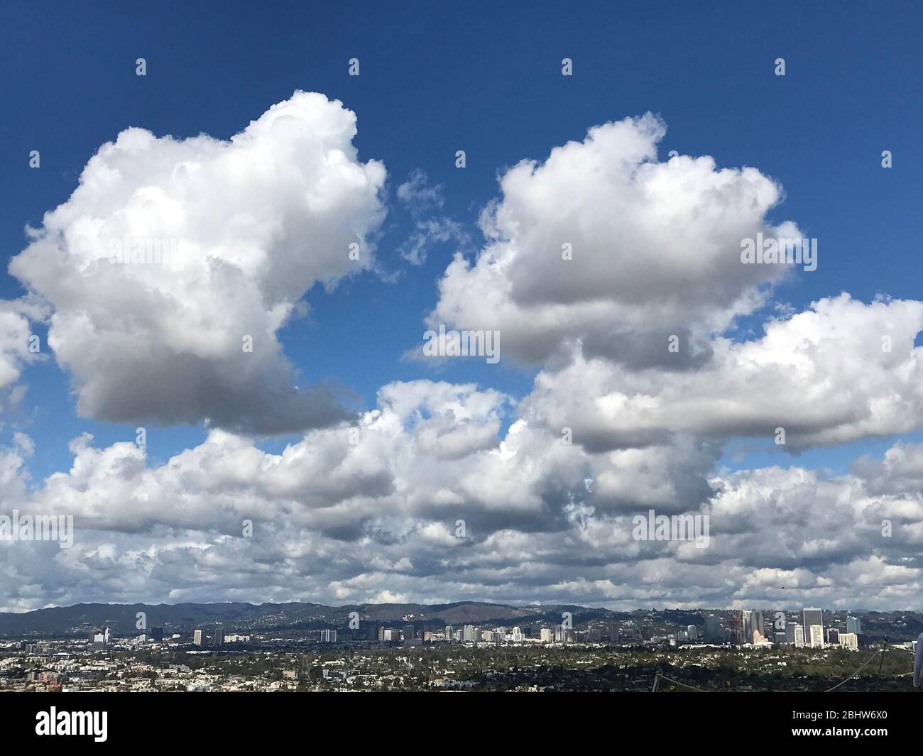 View over L.A. basin from the Baldwin HIlls Scenic Overlook Park with large puffy clouds and clear air , Stock Photo