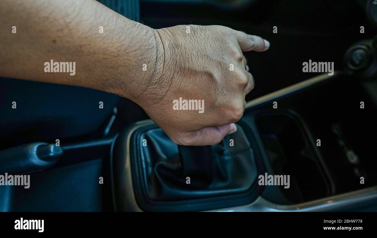 the hand holding the car gear shift lever Stock Photo