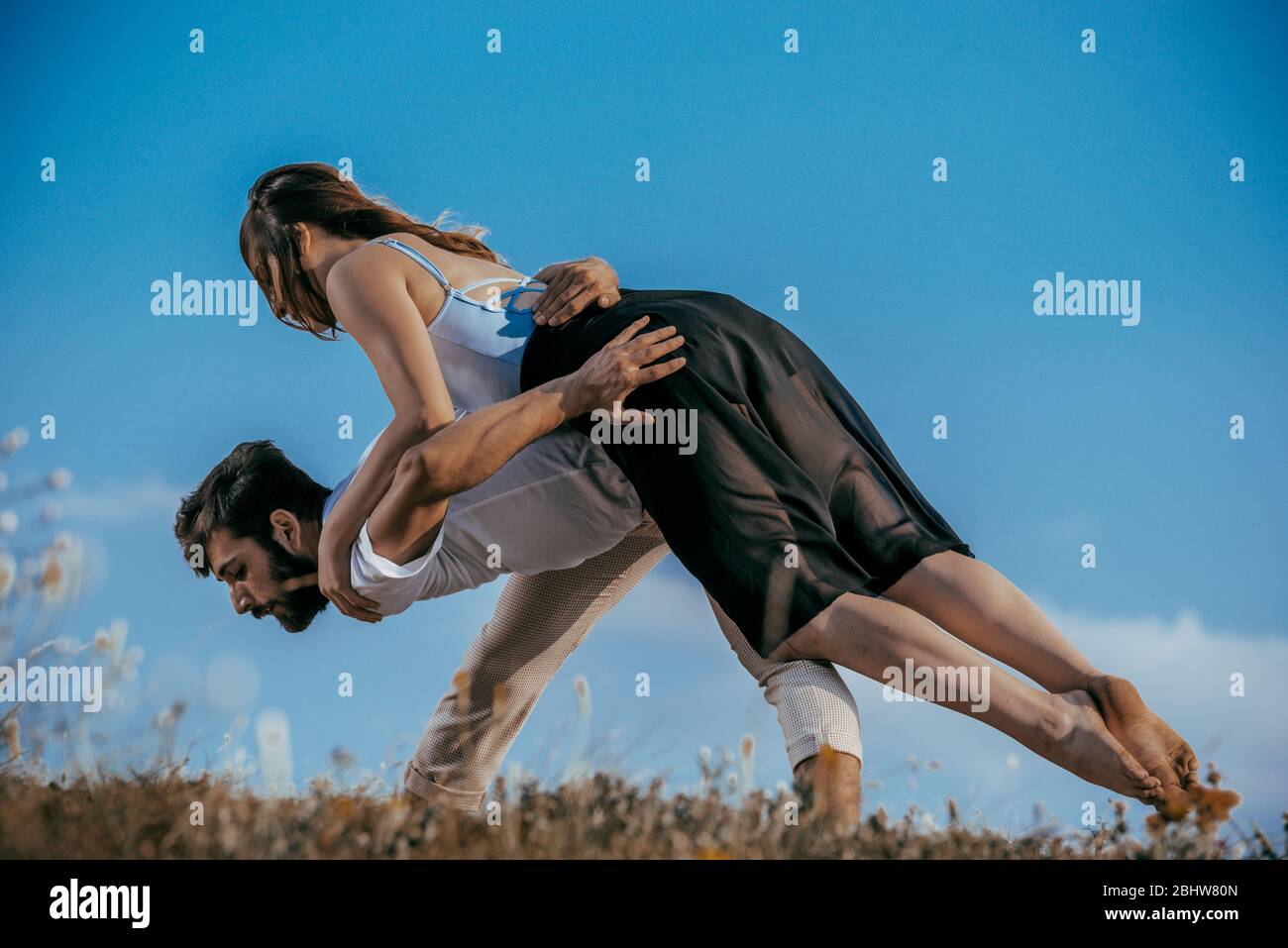 Young beautiful barefoot couple dancer practicing modern dance Stock Photo