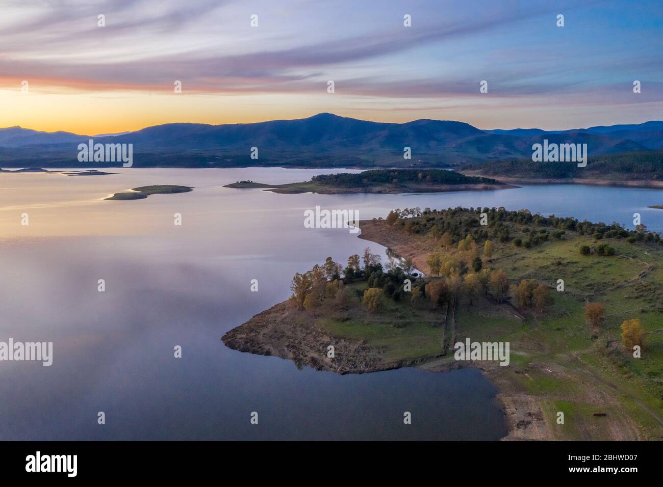 Aerial view of Gabriel y Galan lake at Extremadura countryside. An amazing view during a colourful sunset on a cloudy day. An amazing scenery Stock Photo