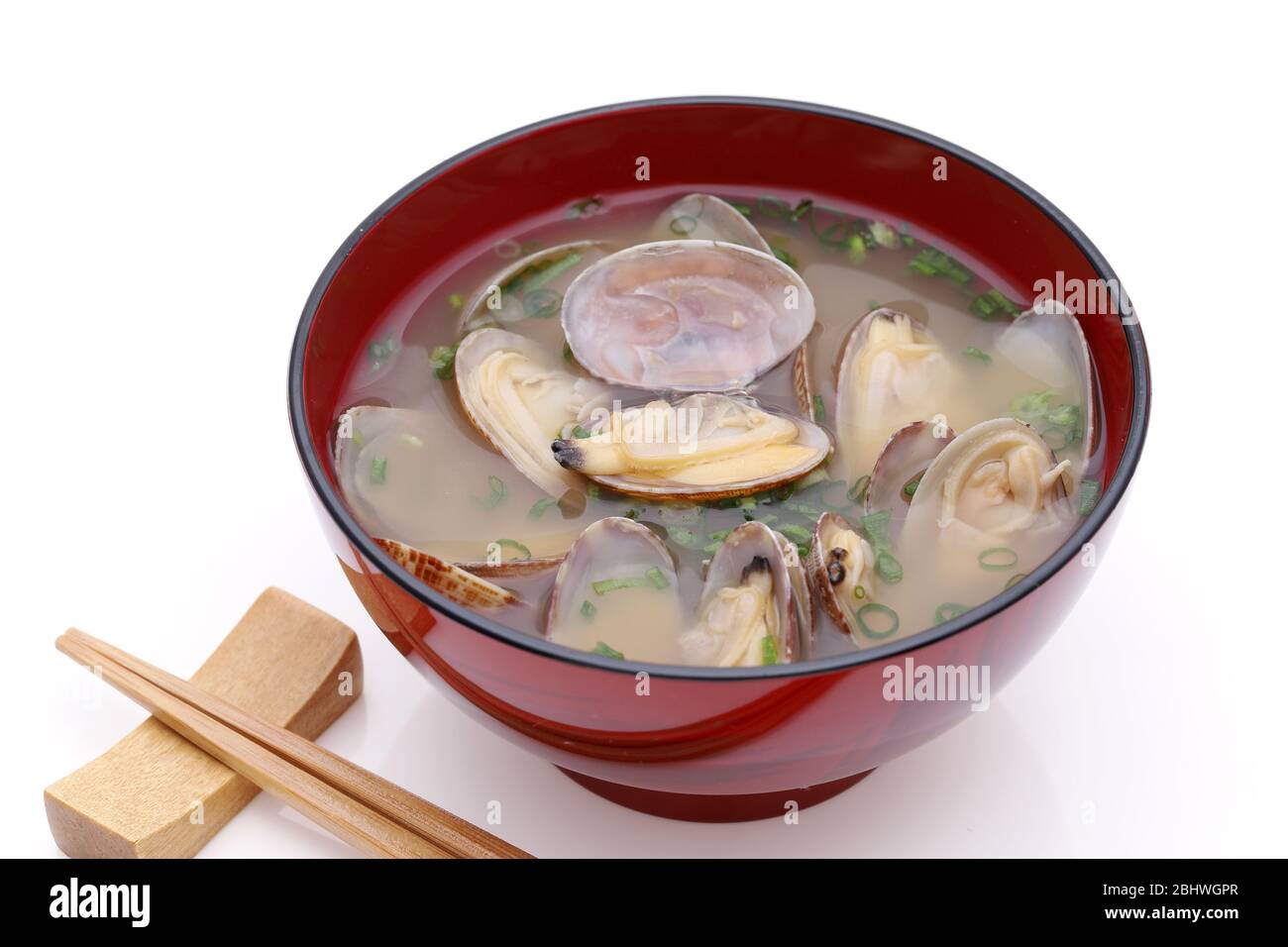 Japanese cuisine miso soup, asari clam held with chopstick isolated on