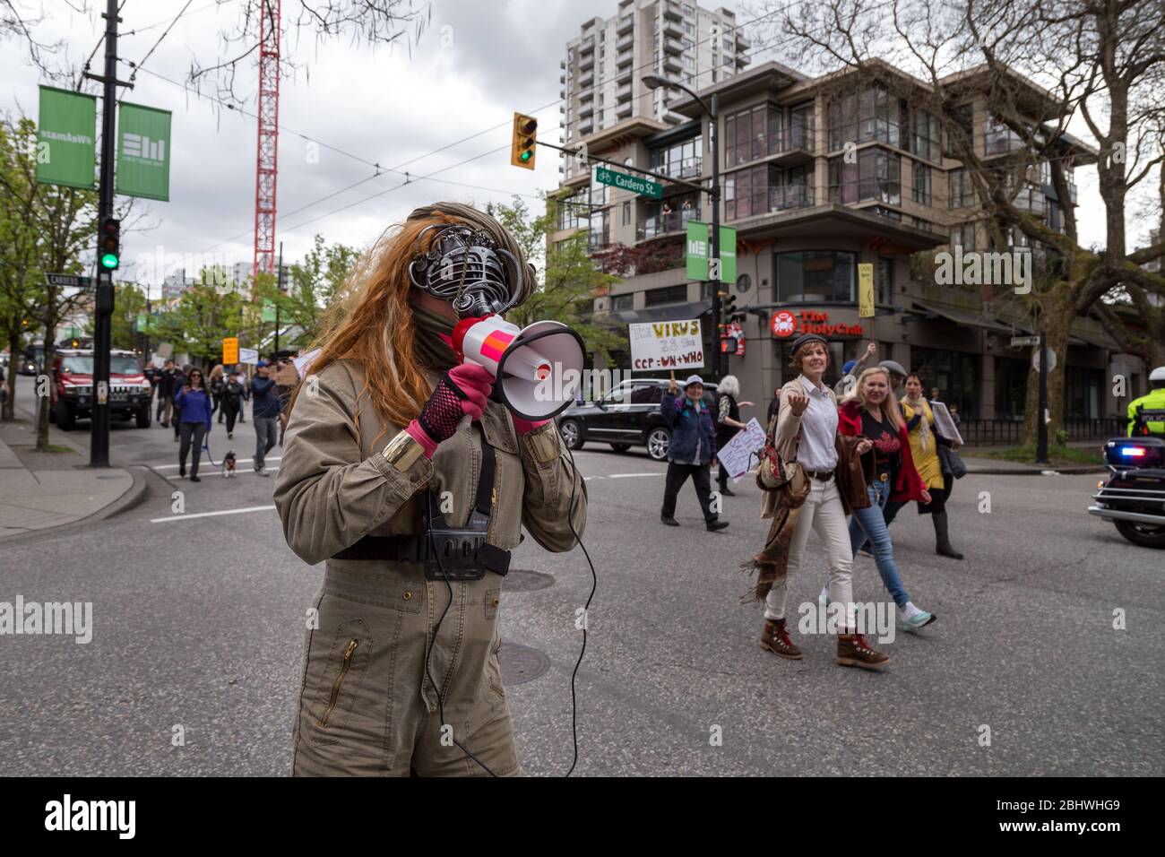 DOWNTOWN VANCOUVER, BC, CANADA - APR 26, 2020: An antifa member disrupts an anti lockdown protest march. Stock Photo