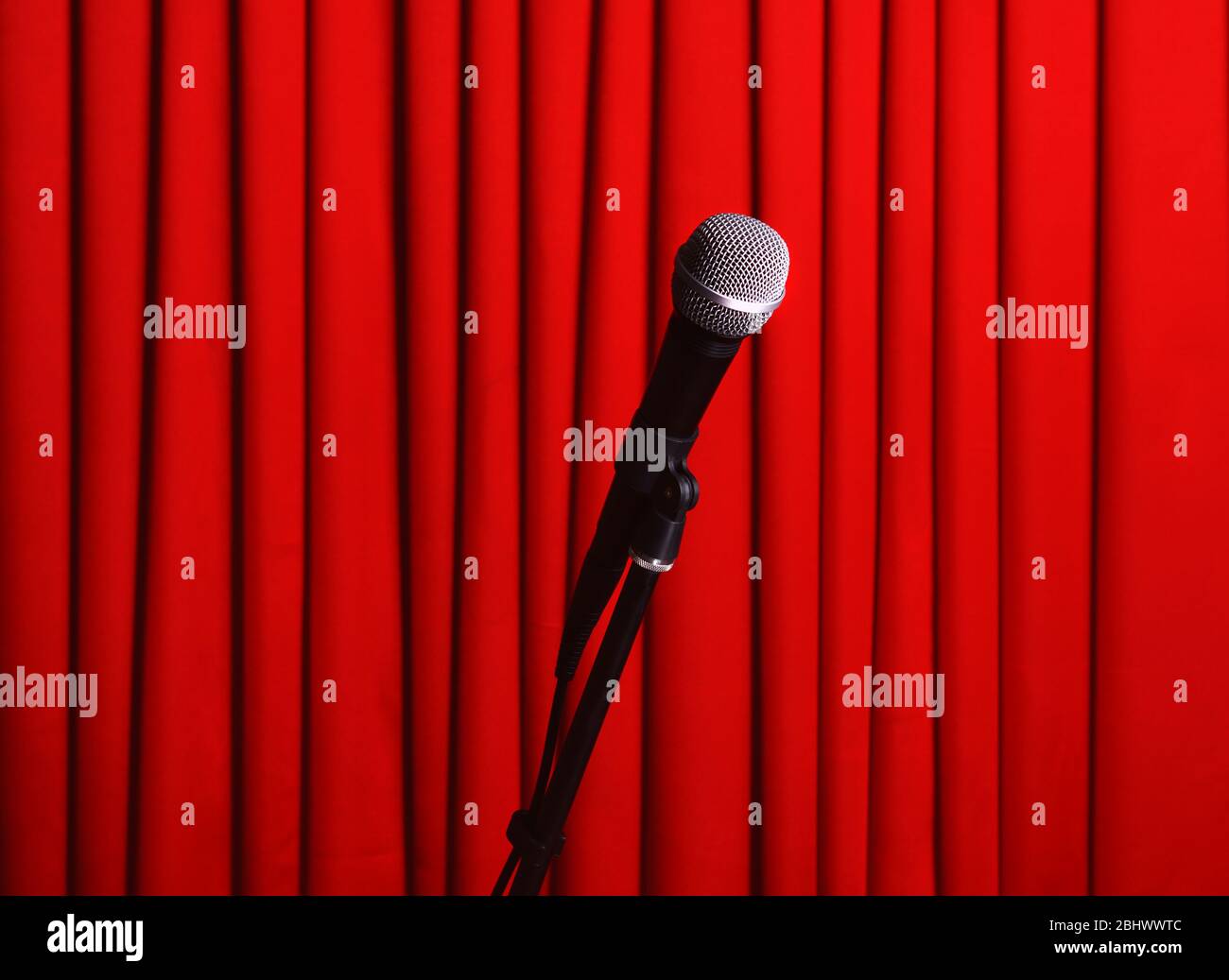 Microphone on stand on red curtain background Stock Photo - Alamy