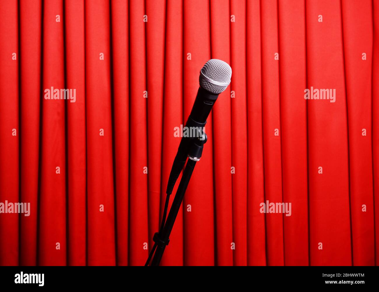 Microphone on stand on red curtain background Stock Photo - Alamy
