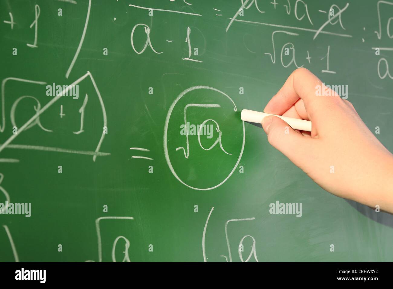 Teacher hand writing formulas on blackboard background Stock Photo - Alamy