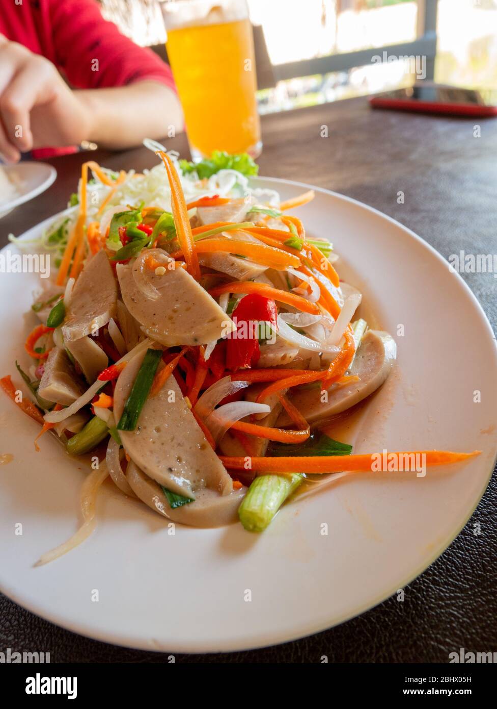 Thaifood of Pork sausage spicy salad Thai and Vietnam food top view on wooden table (Thai name : Yum Moo Yor) Stock Photo