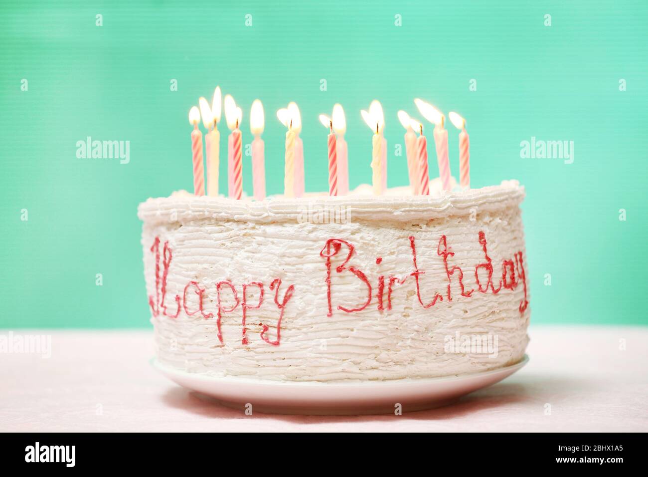 Birthday cake with candles on color background Stock Photo - Alamy