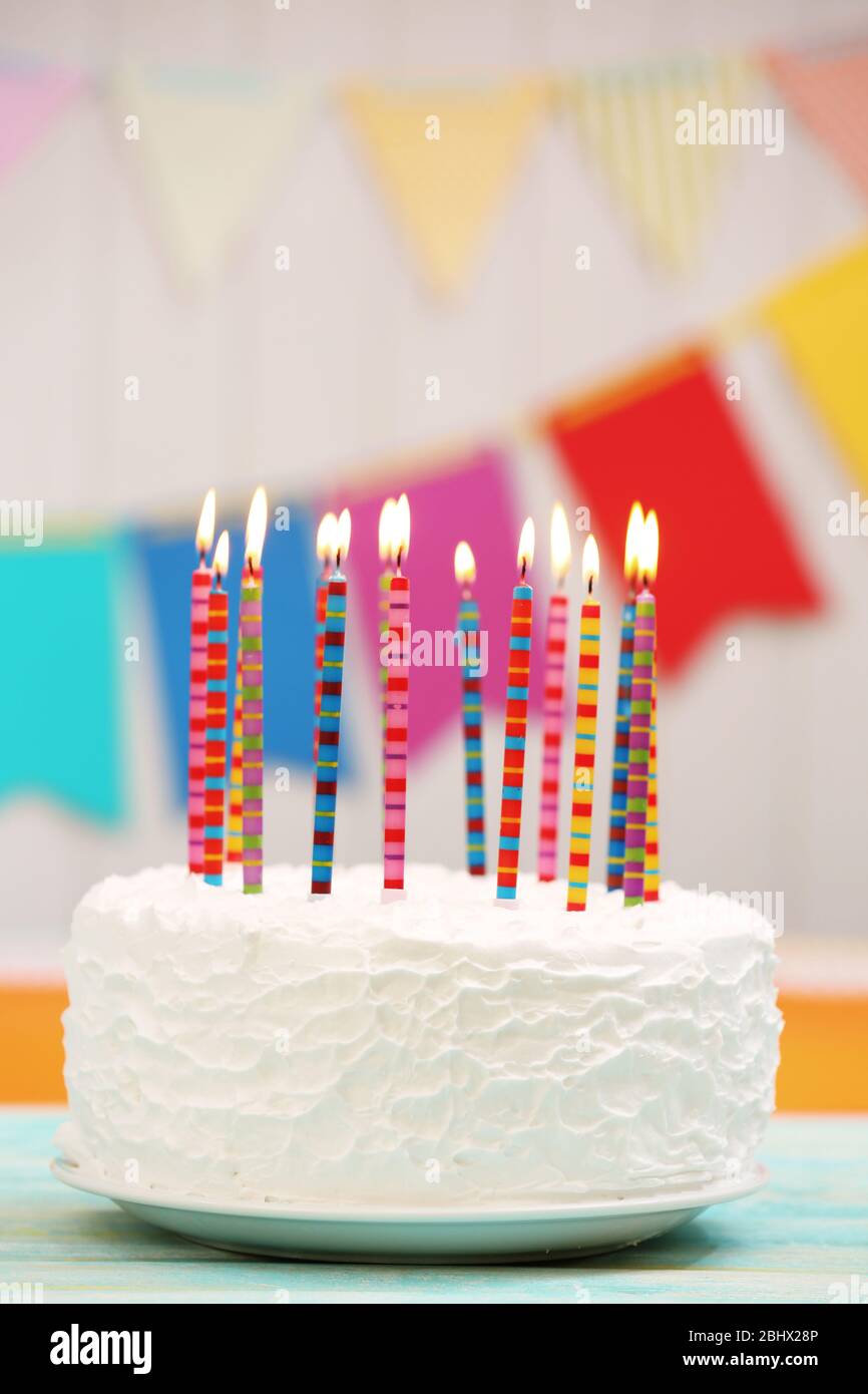 Birthday cake with candles on colorful background Stock Photo - Alamy