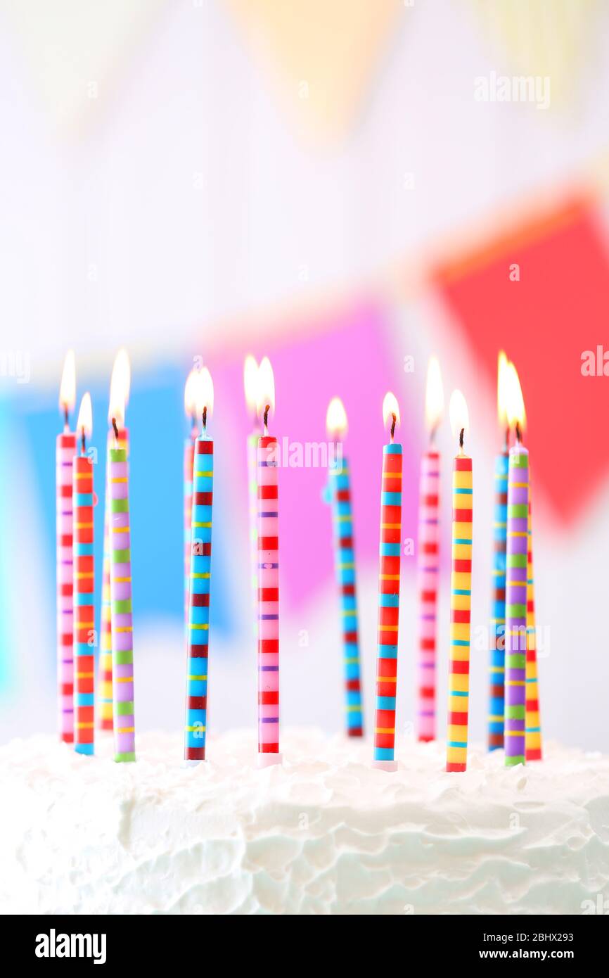 Birthday cake with candles on colorful background Stock Photo - Alamy