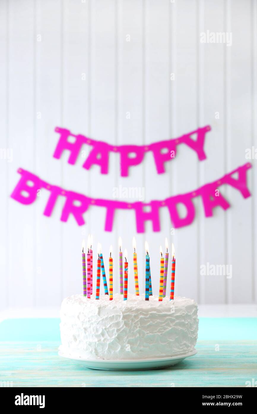 Birthday cake with candles on colorful background Stock Photo - Alamy