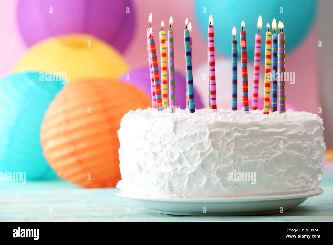 Birthday cake with candles on colorful background Stock Photo - Alamy