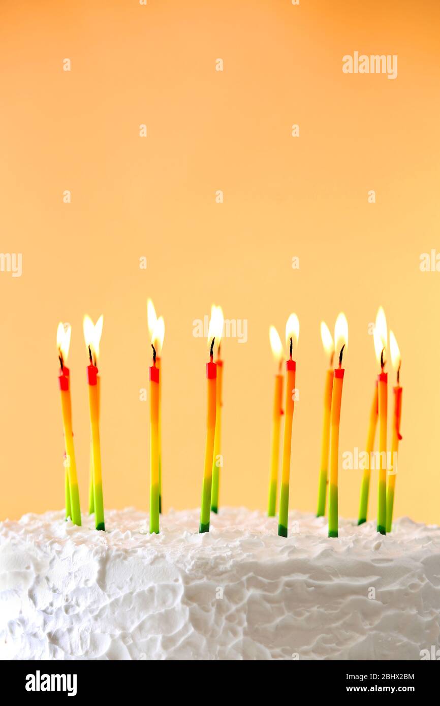 Birthday cake with candles on color background Stock Photo - Alamy
