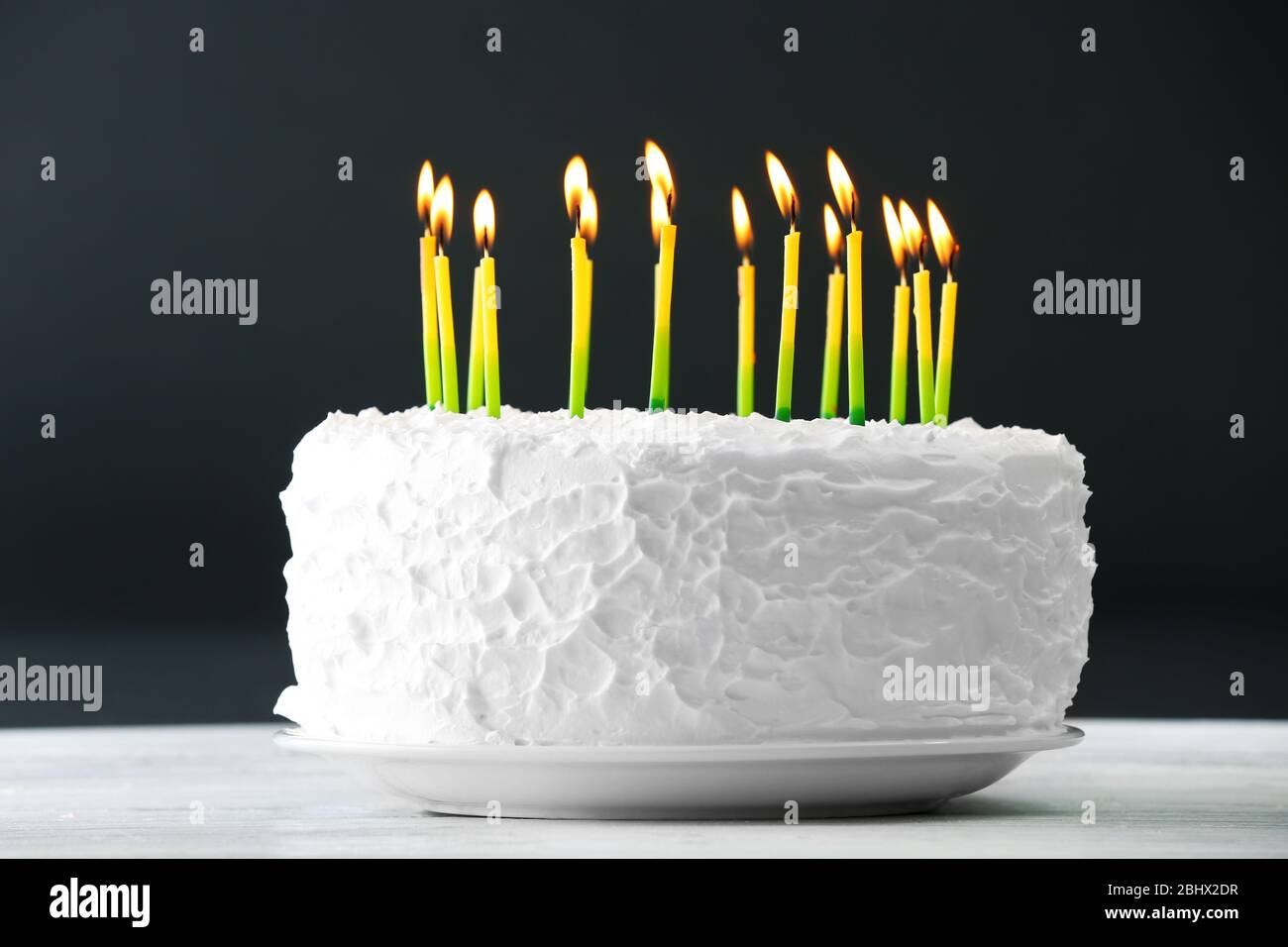 Birthday cake with candles on dark background Stock Photo - Alamy