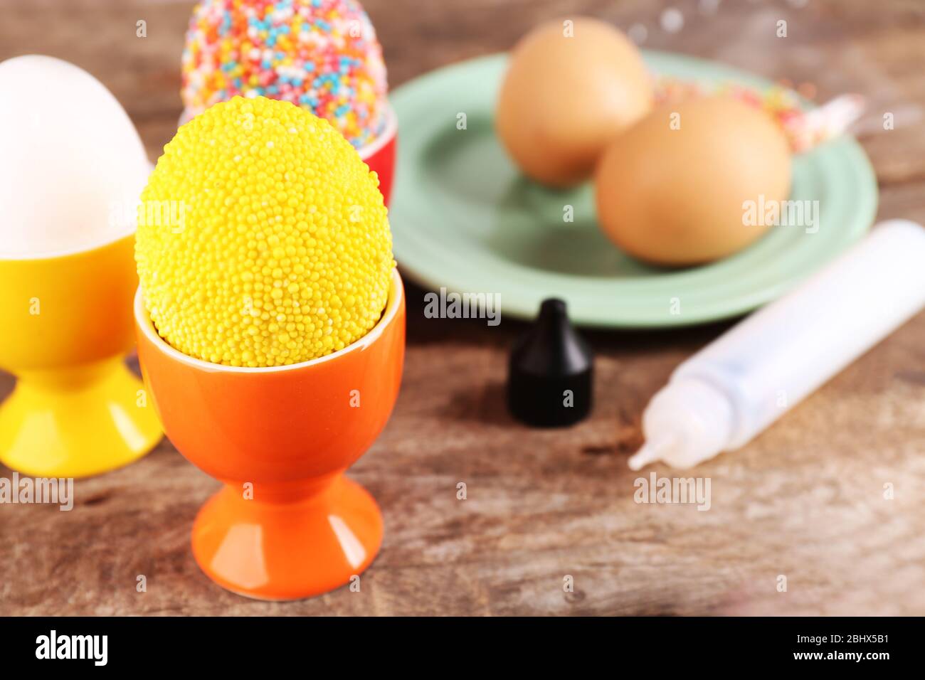 Decoration Easter eggs with colorful beads on wooden table, closeup Stock Photo