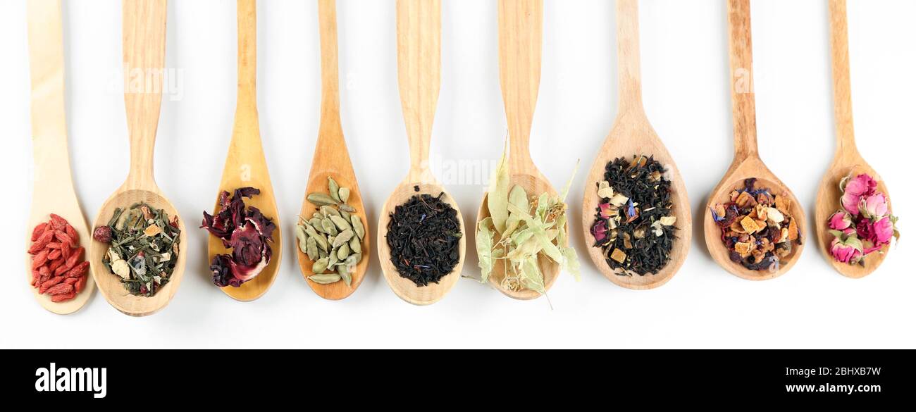Collection of tea and natural additives in wooden spoons, isolated on ...