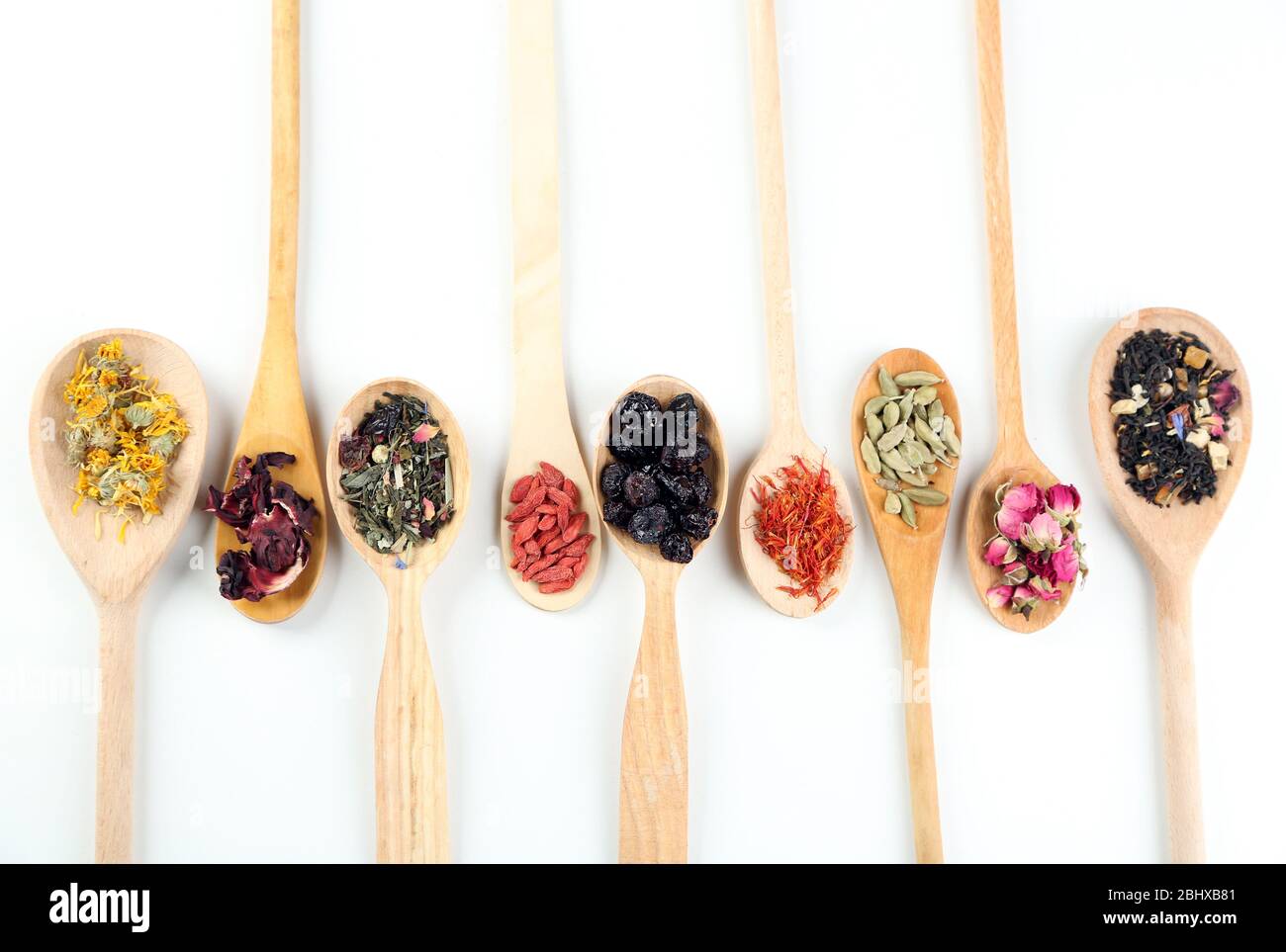 Collection of tea and natural additives in wooden spoons, isolated on ...