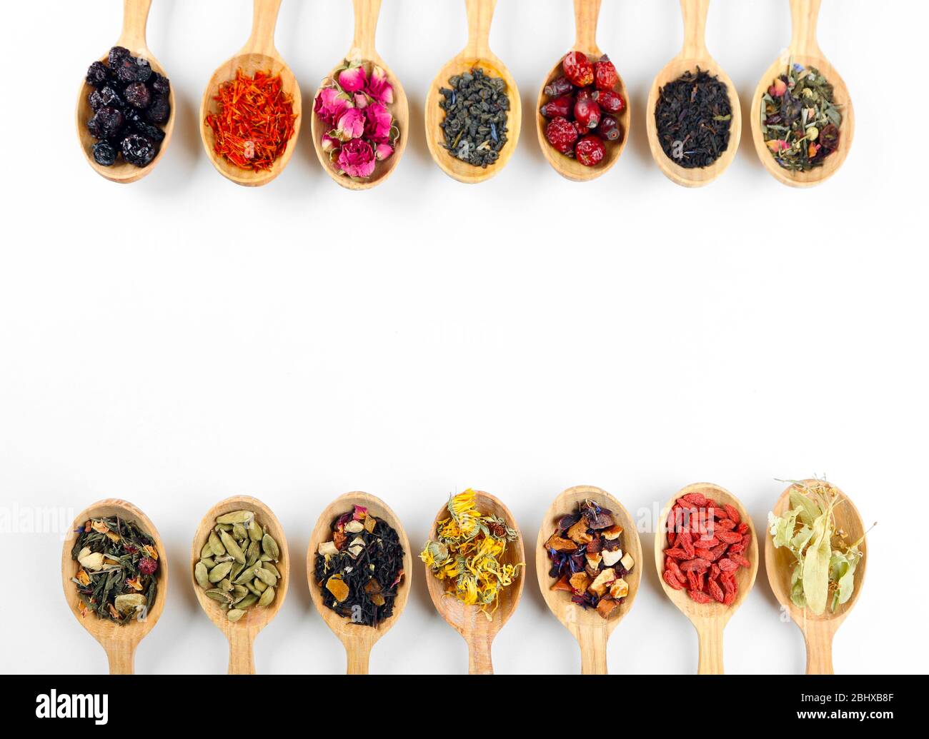 Collection of tea and natural additives in wooden spoons, isolated on ...