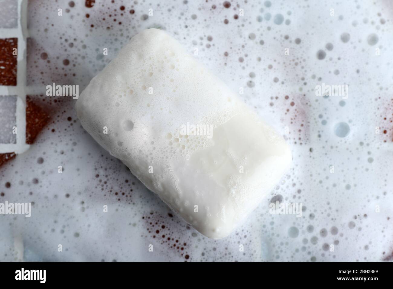 Soap with bubble on mosaic tiles background Stock Photo - Alamy