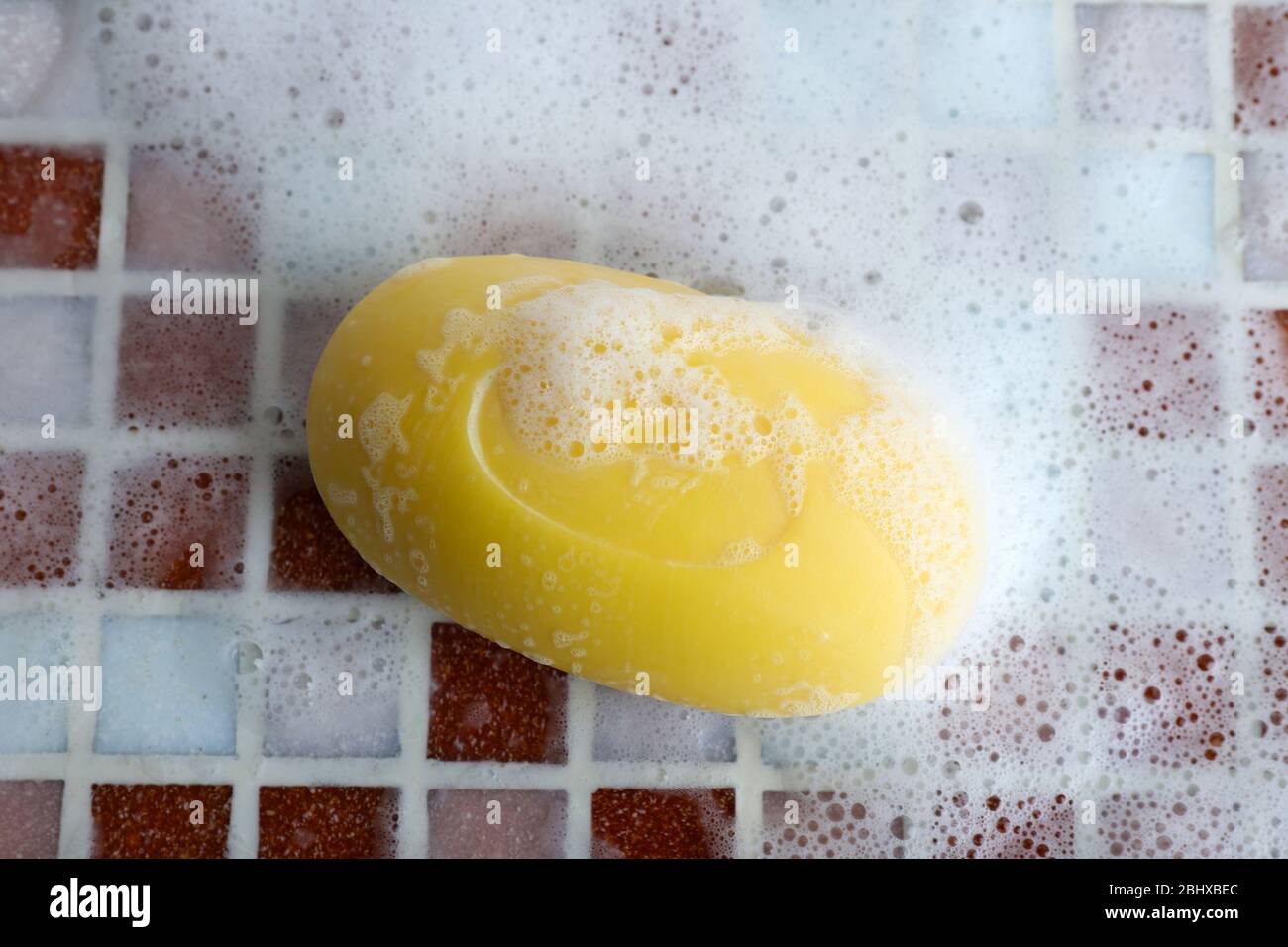 Soap with bubble on mosaic tiles background Stock Photo - Alamy