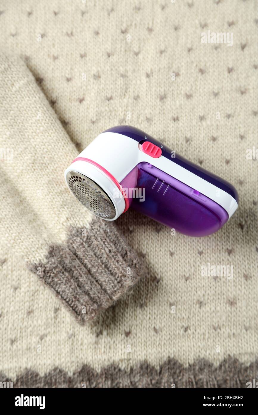 Wool shaver on wool sweater background Stock Photo