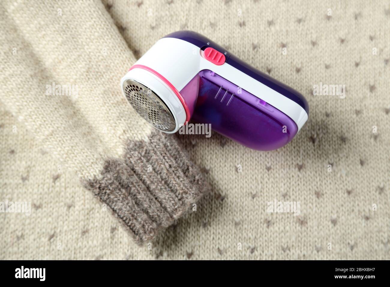 Wool shaver on wool sweater background Stock Photo