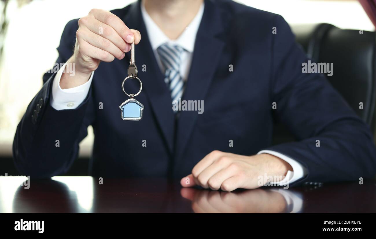 Businessman with keys in his hand in office Stock Photo - Alamy