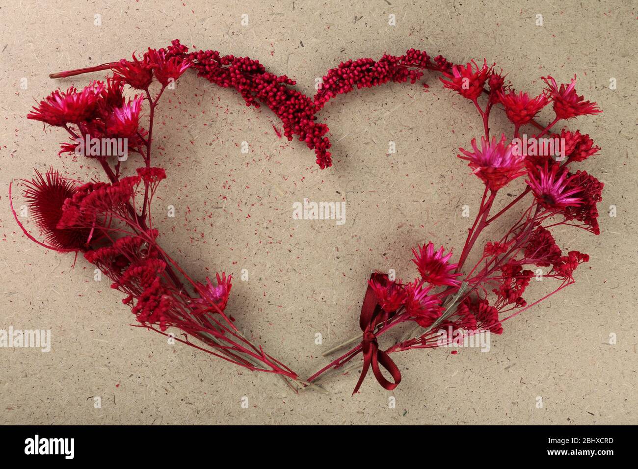 Wildflowers in shape of heart on plywood background Stock Photo - Alamy