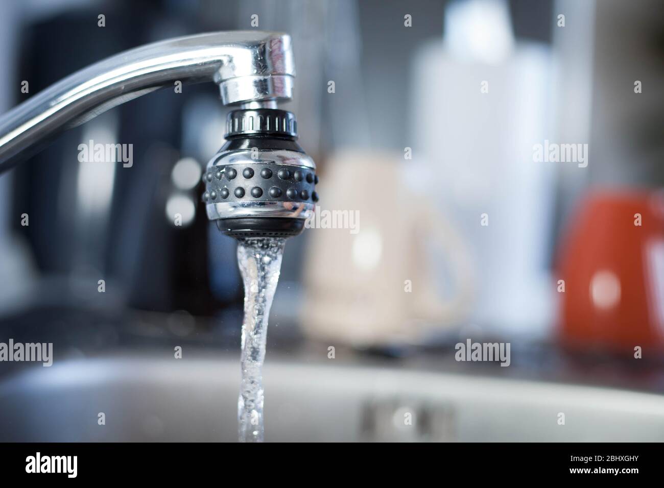 Silver kitchen tap running to the sink Stock Photo Alamy