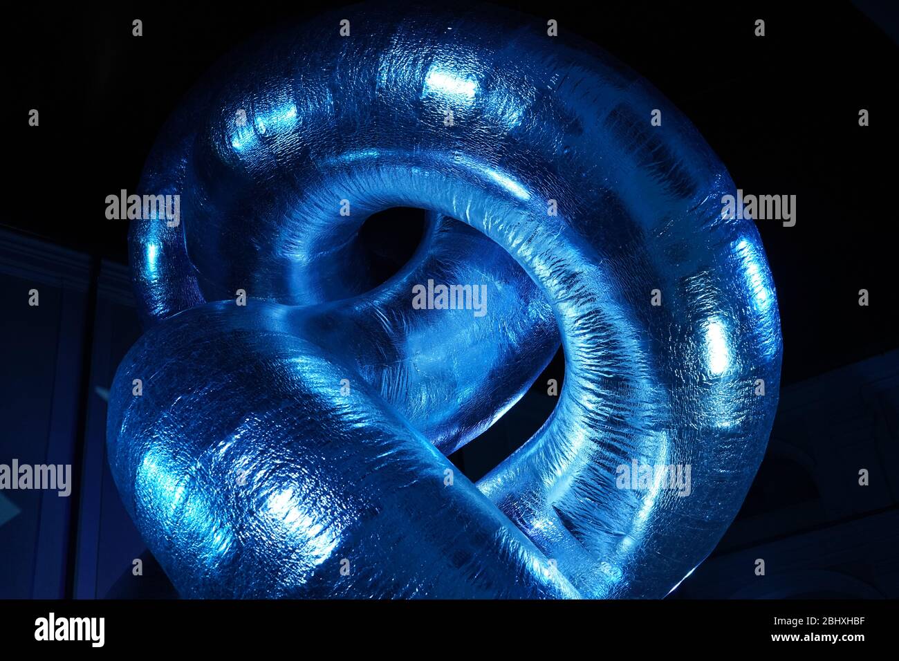 Strange shape sculpture illuminated by blue light Stock Photo