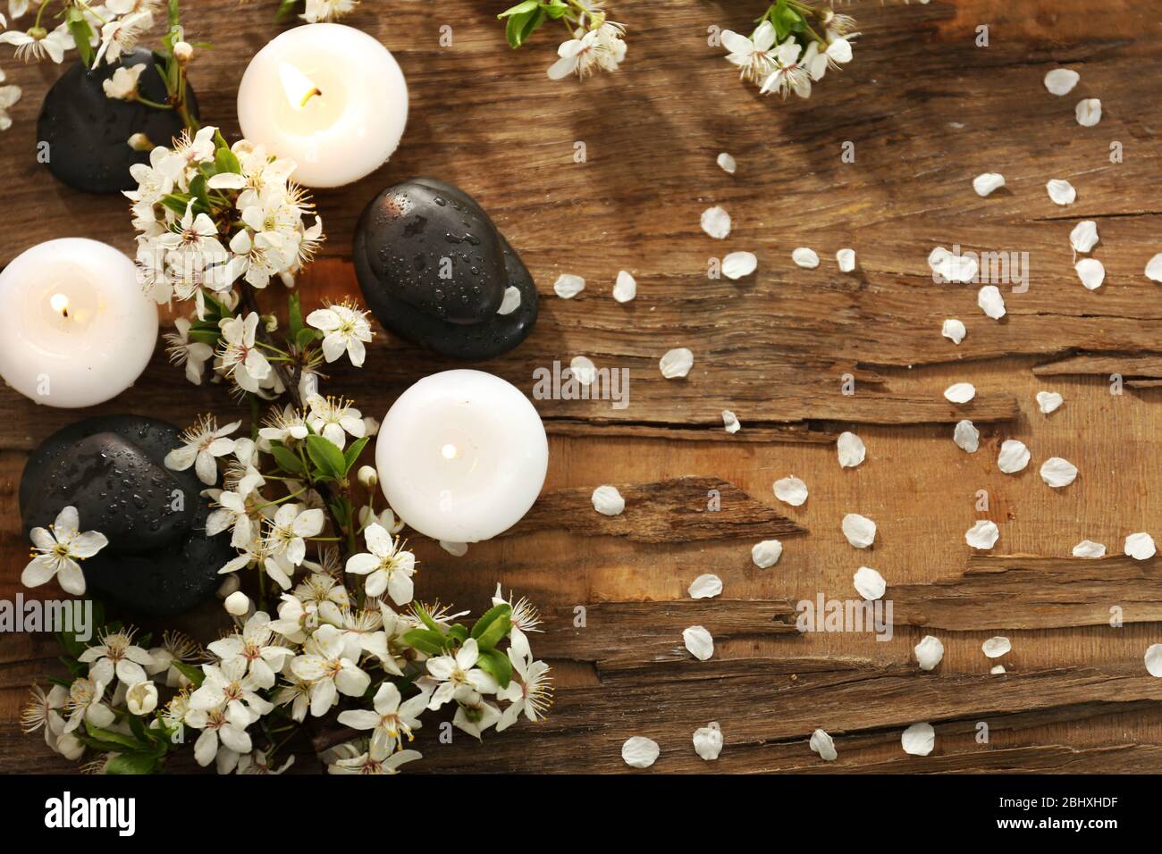 Spa stones with candles and spring flowers on table close up Stock ...