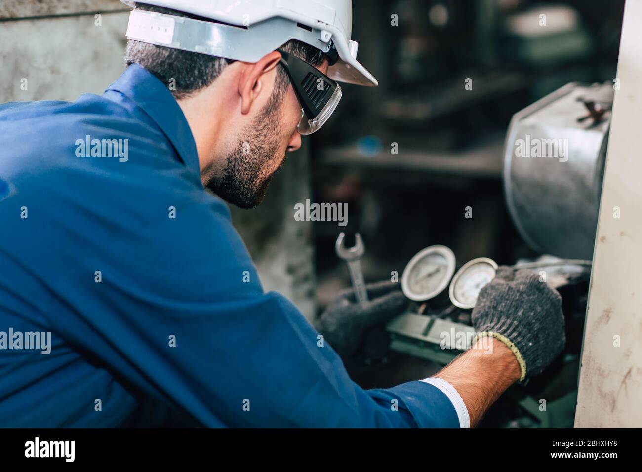 Machine repair fixing pressure gauge of machine in factory need to service and check. Stock Photo
