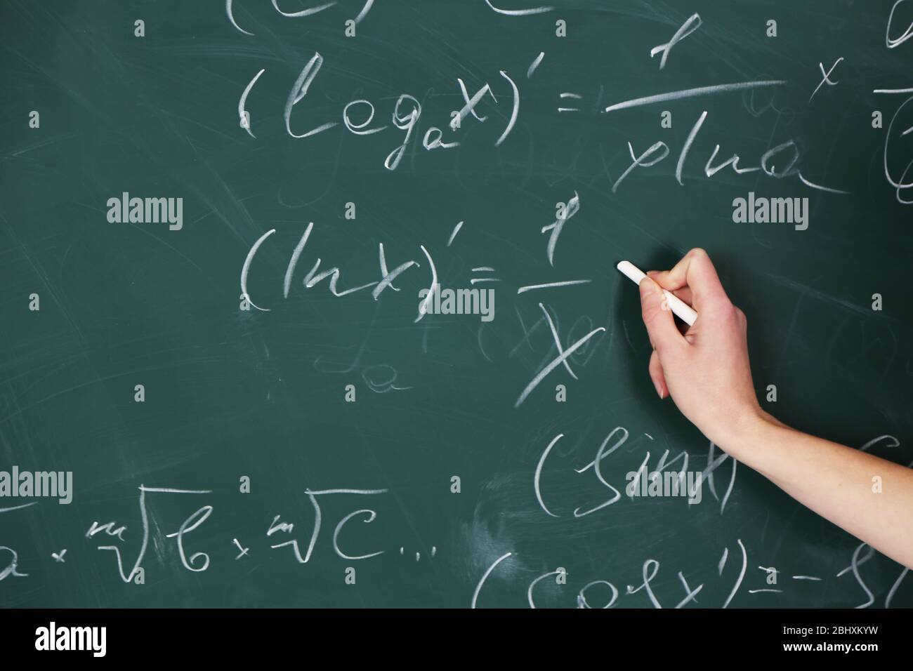 Female hand writing formulas on blackboard with chalk, close up Stock ...