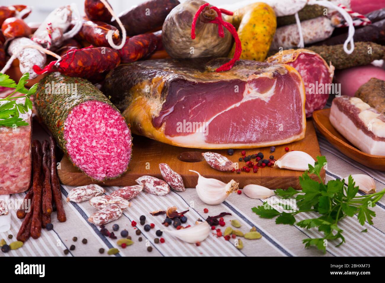 Variety of meats, sausages and mince with herbs on table Stock Photo