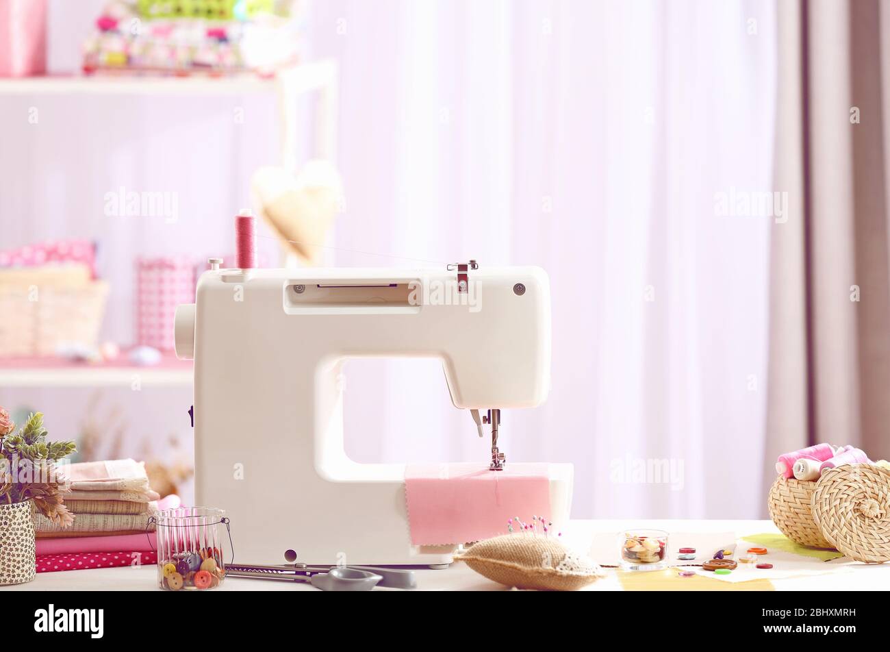 Sewing machine on table in Stock Photo Alamy