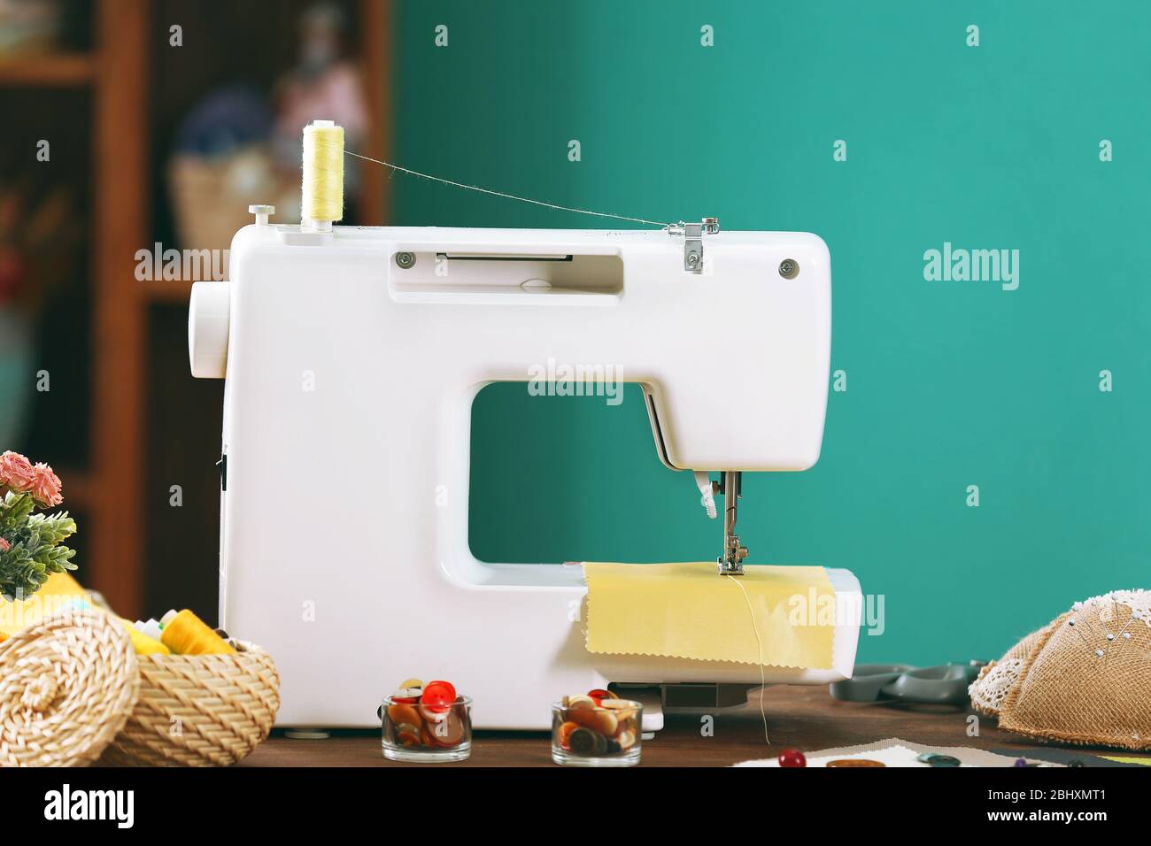 Sewing machine on table in Stock Photo Alamy