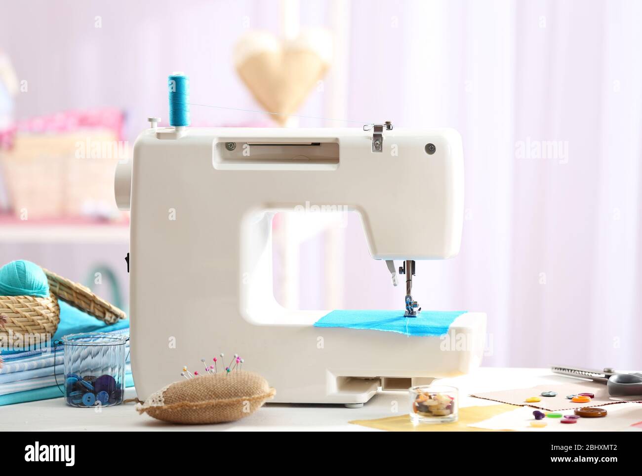 Sewing machine on table in Stock Photo Alamy