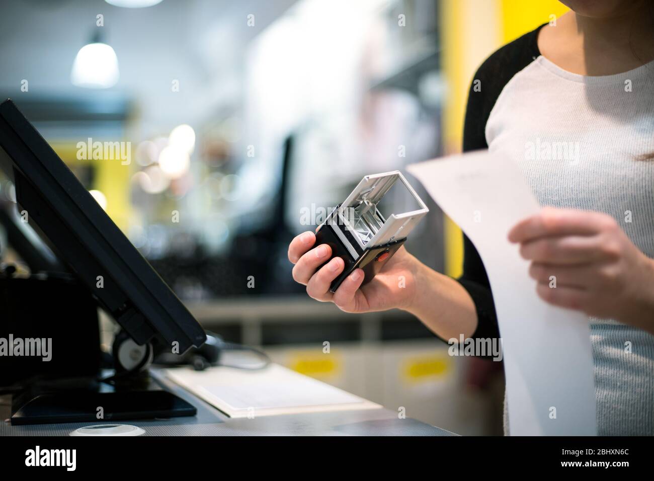 saleswoman, shopgirl giving a stamp on a receipt, invoice for a customer, sales time, discount period, finance concept Stock Photo