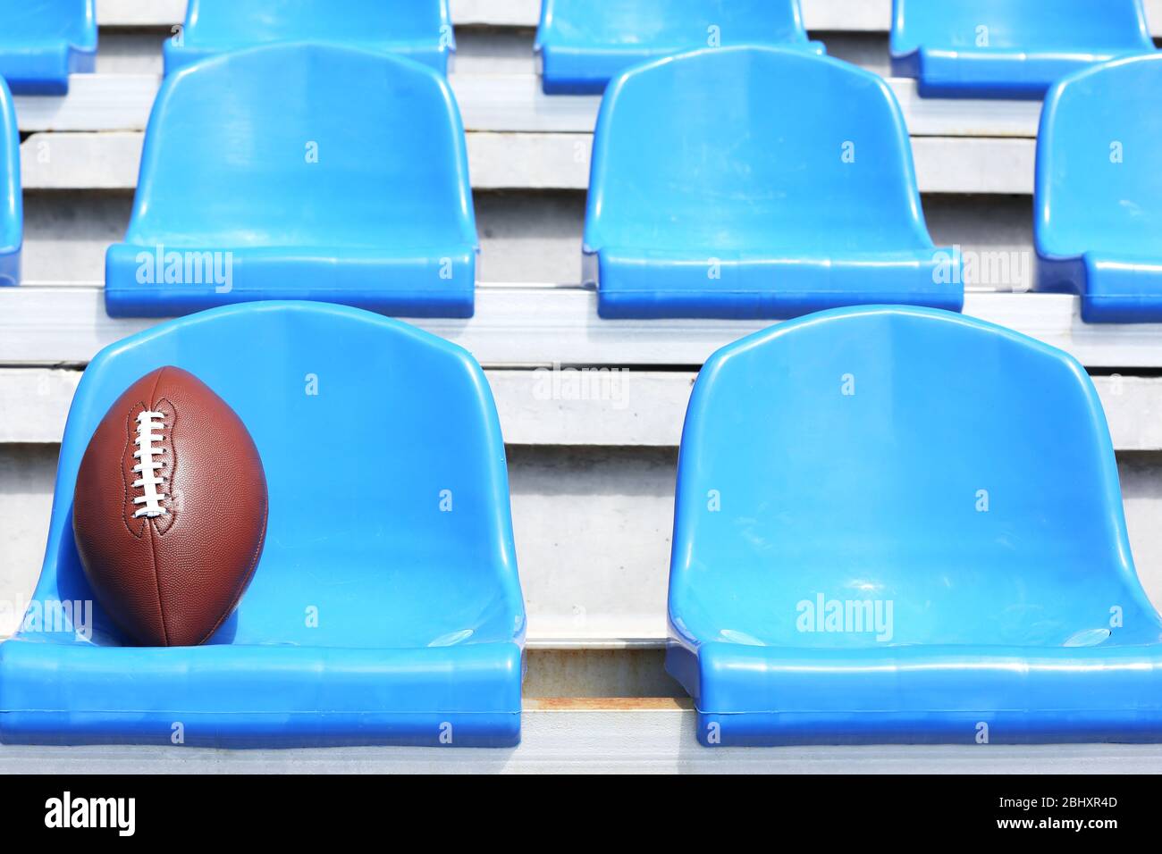 Rugby ball on stadium seat Stock Photo Alamy