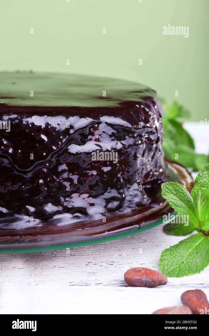Delicious chocolate cake with icing in plate on table, closeup Stock ...